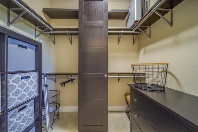 spacious closet with light tile patterned floors