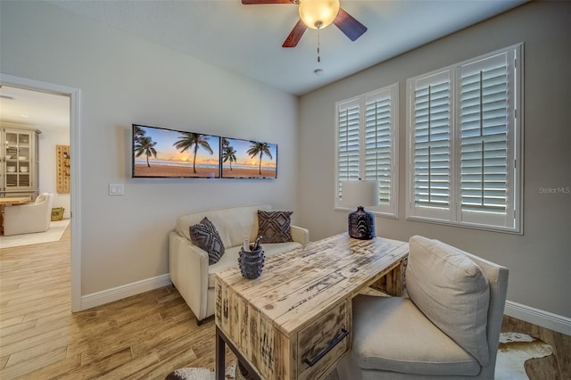 home office with ceiling fan and light hardwood / wood-style flooring