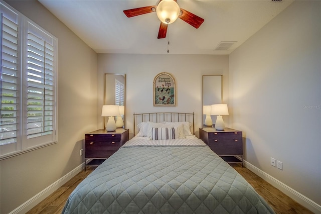 bedroom with ceiling fan and hardwood / wood-style flooring