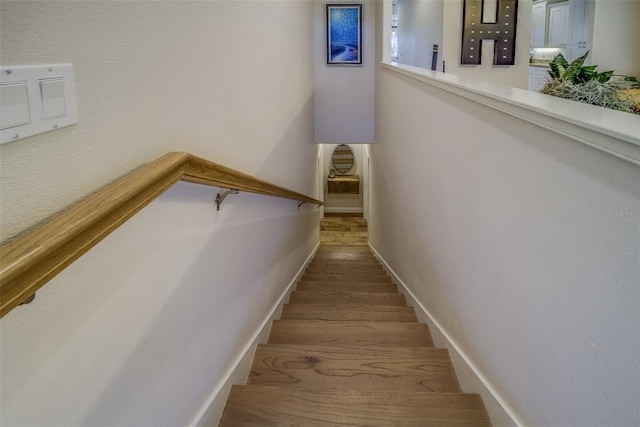 staircase with hardwood / wood-style flooring