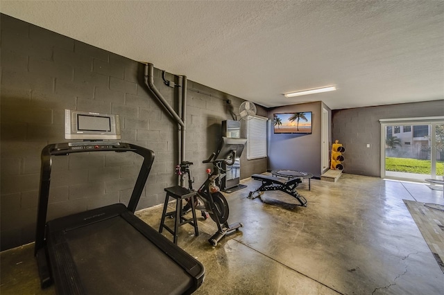 exercise room featuring a textured ceiling