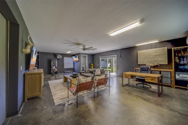 living room with a textured ceiling and ceiling fan