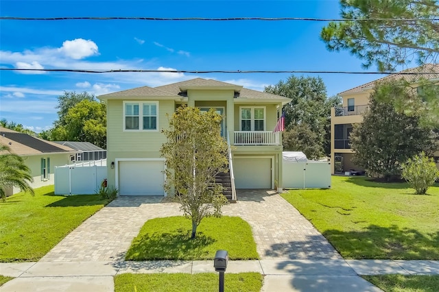 view of front of property with a front yard and a balcony