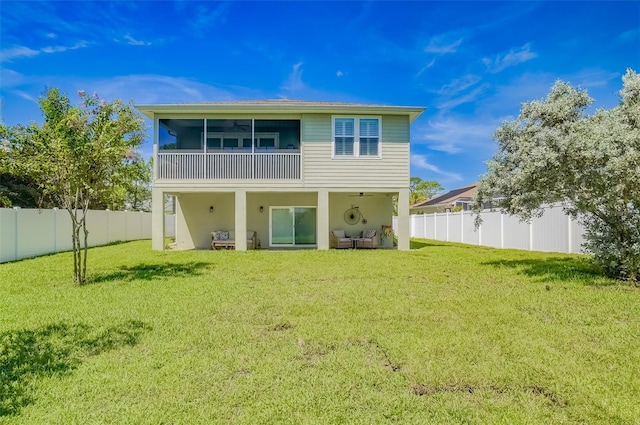 back of property with a lawn and a sunroom