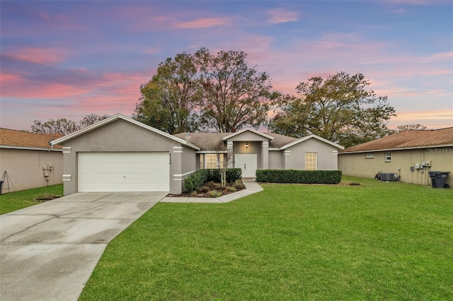 single story home with a yard and a garage