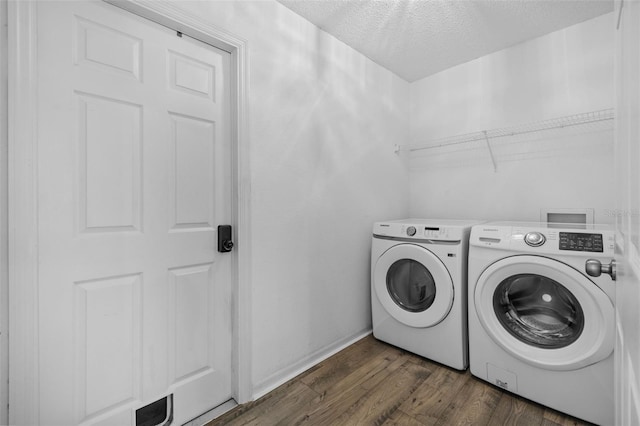 clothes washing area with dark wood-type flooring, a textured ceiling, and independent washer and dryer