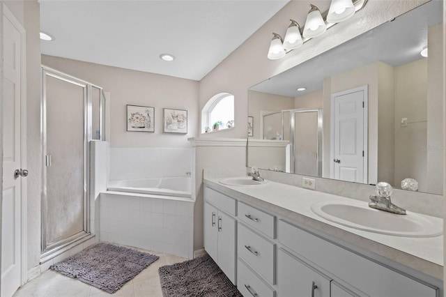 bathroom featuring separate shower and tub, vanity, and tile patterned floors