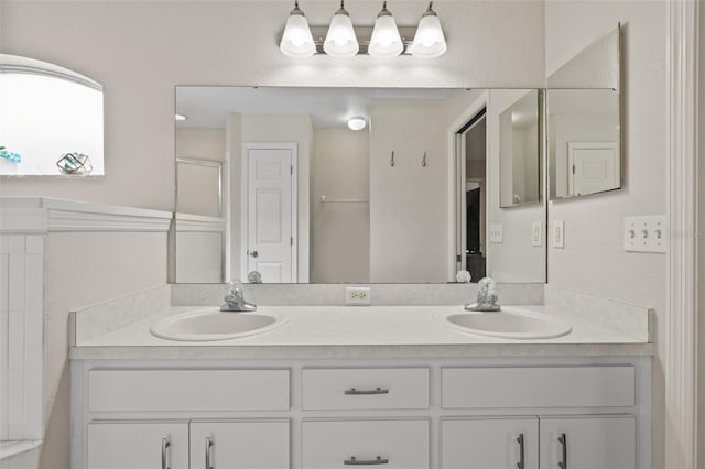 bathroom featuring an enclosed shower and vanity