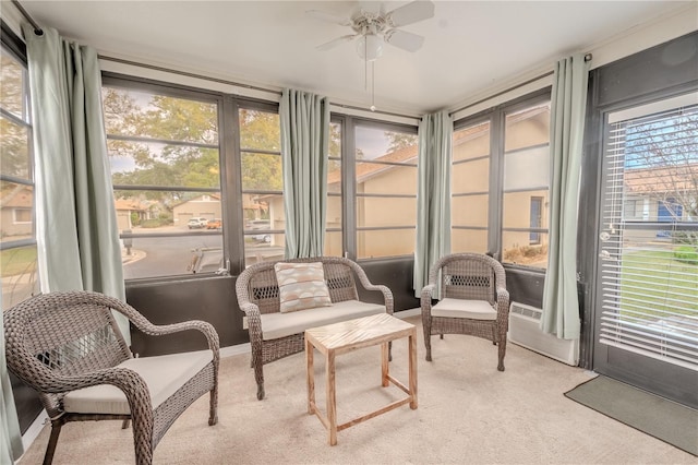 sunroom / solarium with a wealth of natural light and ceiling fan