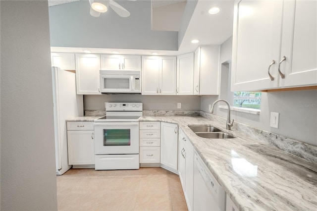 kitchen featuring white appliances, sink, and white cabinets