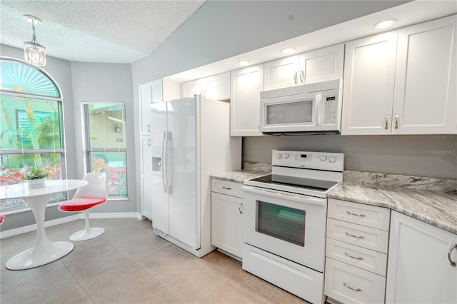 kitchen with a textured ceiling, light tile patterned floors, hanging light fixtures, white appliances, and white cabinets