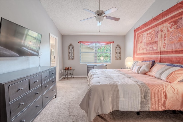 carpeted bedroom featuring lofted ceiling, ceiling fan, a textured ceiling, and ensuite bathroom