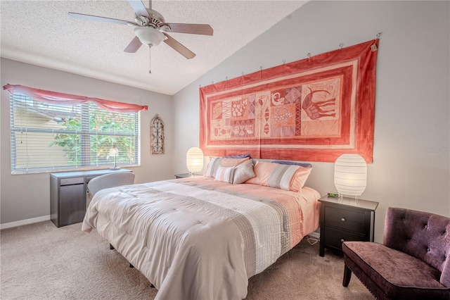 bedroom with ceiling fan, lofted ceiling, light colored carpet, and a textured ceiling