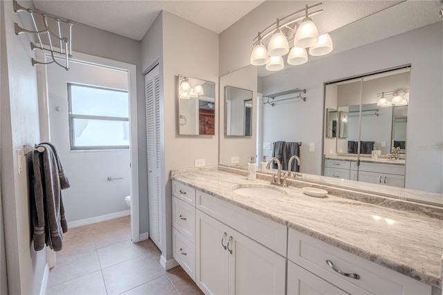 bathroom featuring tile patterned floors, toilet, and vanity