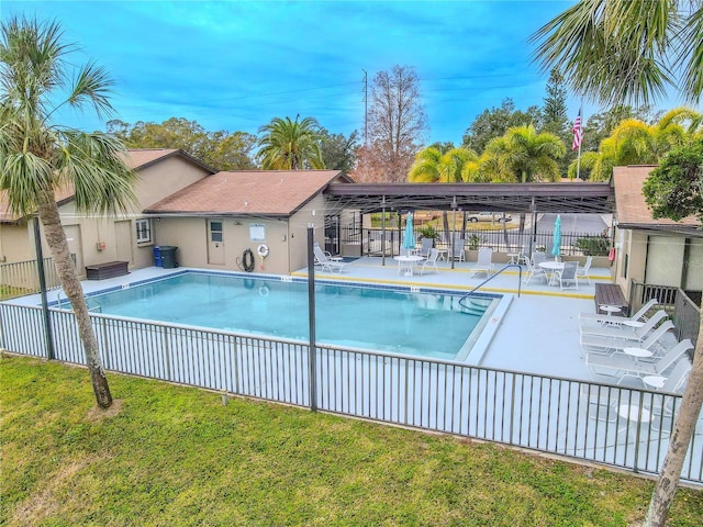 view of pool with a yard and a patio