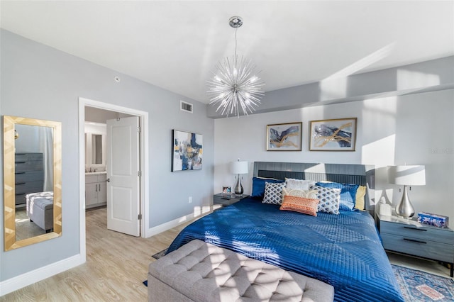 bedroom featuring an inviting chandelier and light wood-type flooring