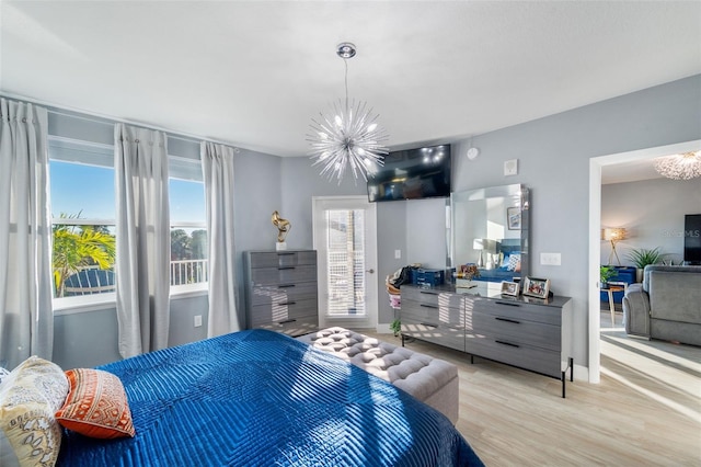 bedroom with a chandelier and light hardwood / wood-style flooring