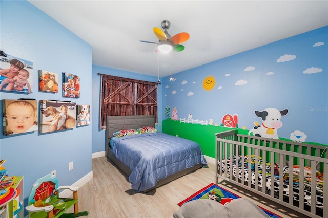 bedroom with light hardwood / wood-style flooring and ceiling fan