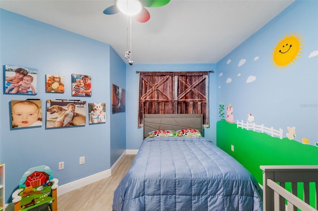 bedroom with ceiling fan and wood-type flooring