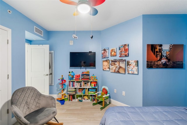 bedroom with ceiling fan and hardwood / wood-style floors