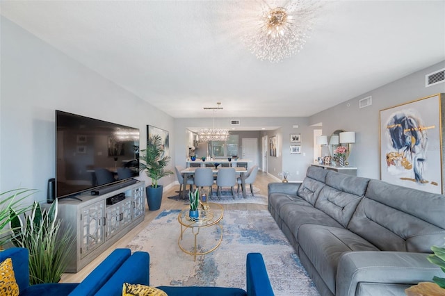 living room featuring a notable chandelier and wood-type flooring