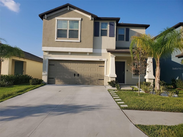 view of front of property featuring a front lawn and a garage