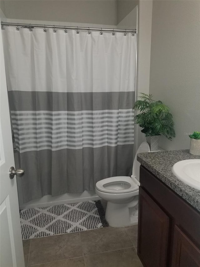 bathroom featuring tile patterned floors, toilet, and vanity