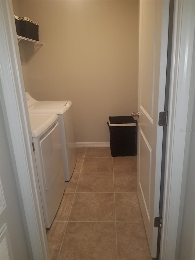 laundry area with tile patterned floors and washing machine and dryer