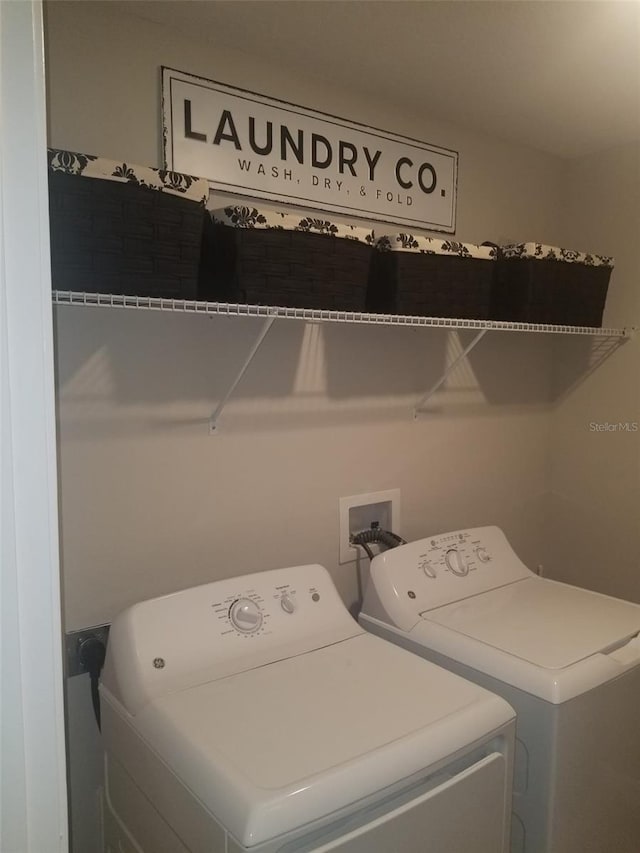 clothes washing area with separate washer and dryer