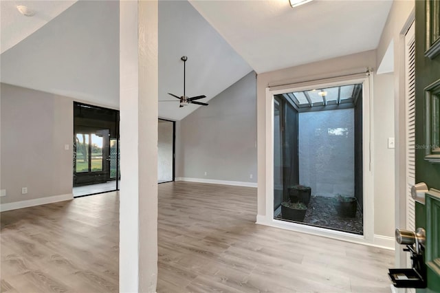 unfurnished living room featuring vaulted ceiling, ceiling fan, and light hardwood / wood-style floors