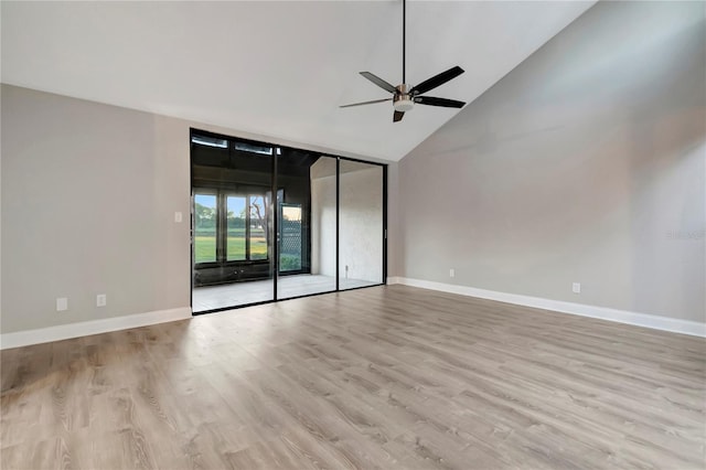 empty room with vaulted ceiling, ceiling fan, and light hardwood / wood-style floors