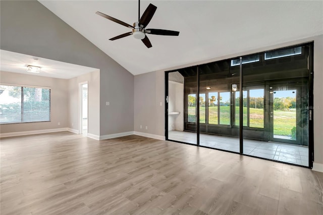 spare room with ceiling fan, light hardwood / wood-style floors, and high vaulted ceiling