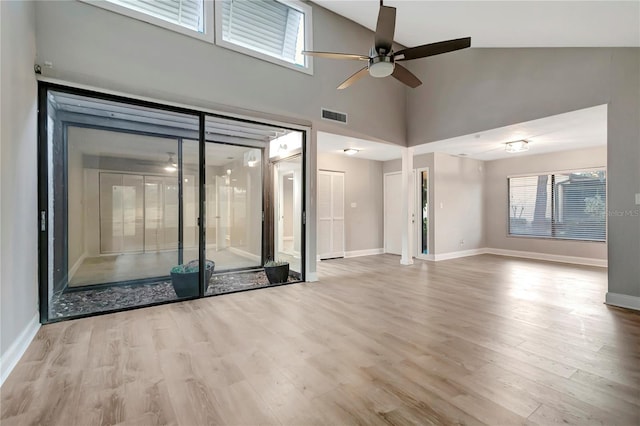 interior space featuring ceiling fan, light wood-type flooring, and high vaulted ceiling