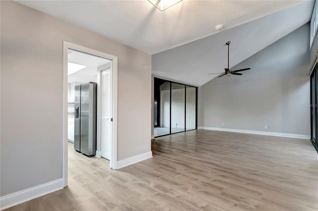 unfurnished living room featuring light hardwood / wood-style floors, ceiling fan, and lofted ceiling