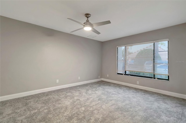 carpeted empty room featuring ceiling fan