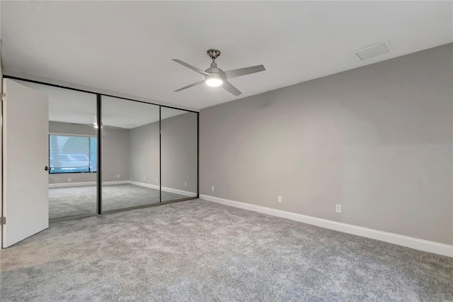 unfurnished bedroom with carpet floors, ceiling fan, and a closet