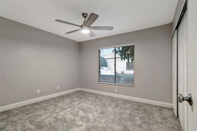 unfurnished room with light carpet and ceiling fan