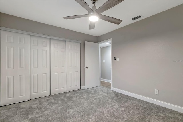 unfurnished bedroom featuring ceiling fan, a closet, and carpet floors