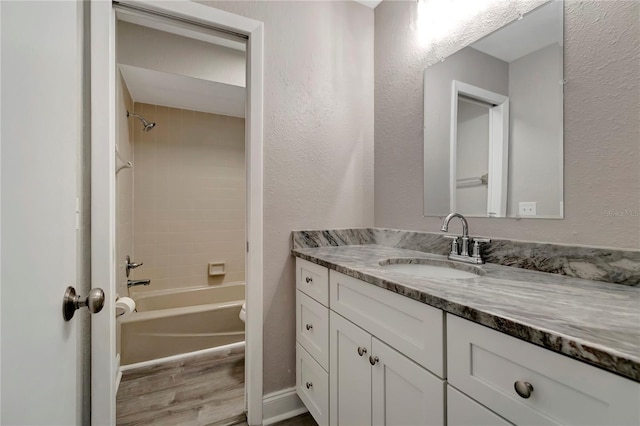 full bathroom featuring toilet, vanity, and tiled shower / bath