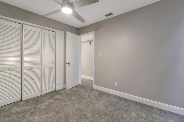 unfurnished bedroom with ceiling fan, light colored carpet, and a closet