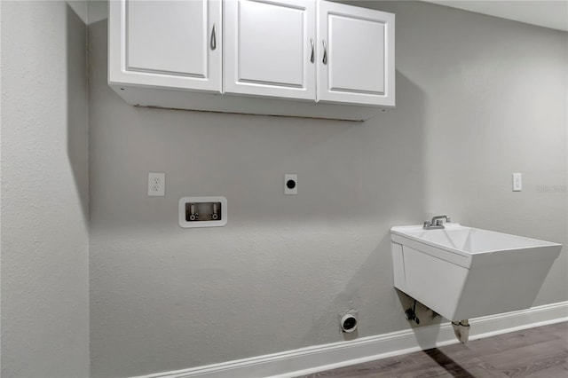 laundry area with hookup for an electric dryer, dark hardwood / wood-style floors, hookup for a washing machine, cabinets, and sink