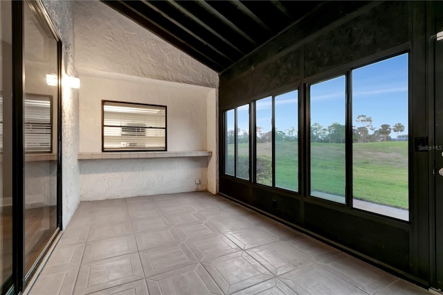 unfurnished sunroom with lofted ceiling