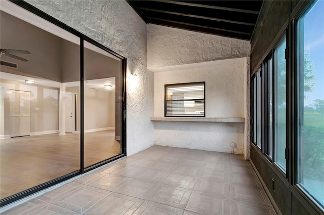 interior space featuring ceiling fan and vaulted ceiling