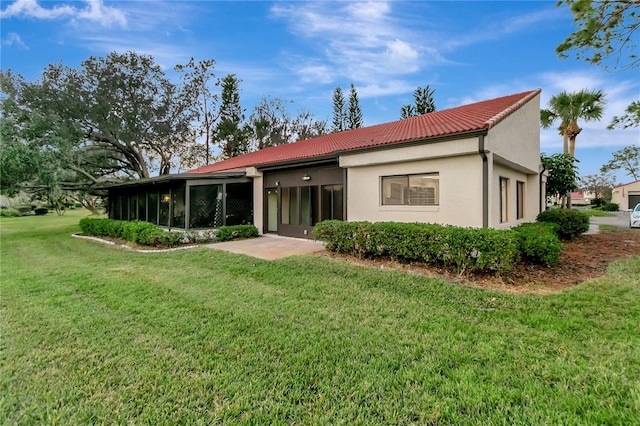 rear view of property with a lawn