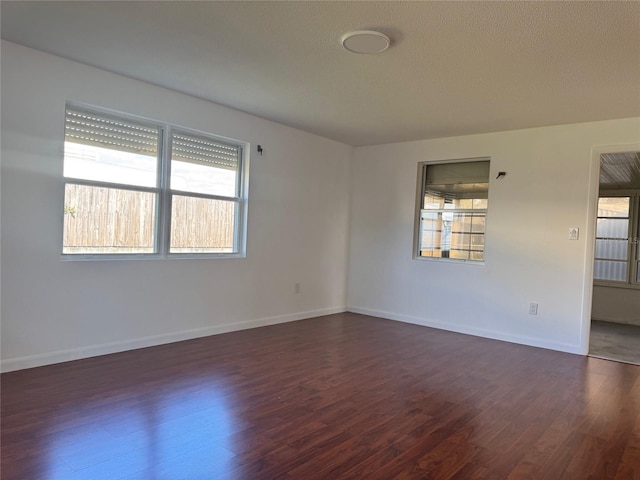 spare room featuring dark hardwood / wood-style flooring