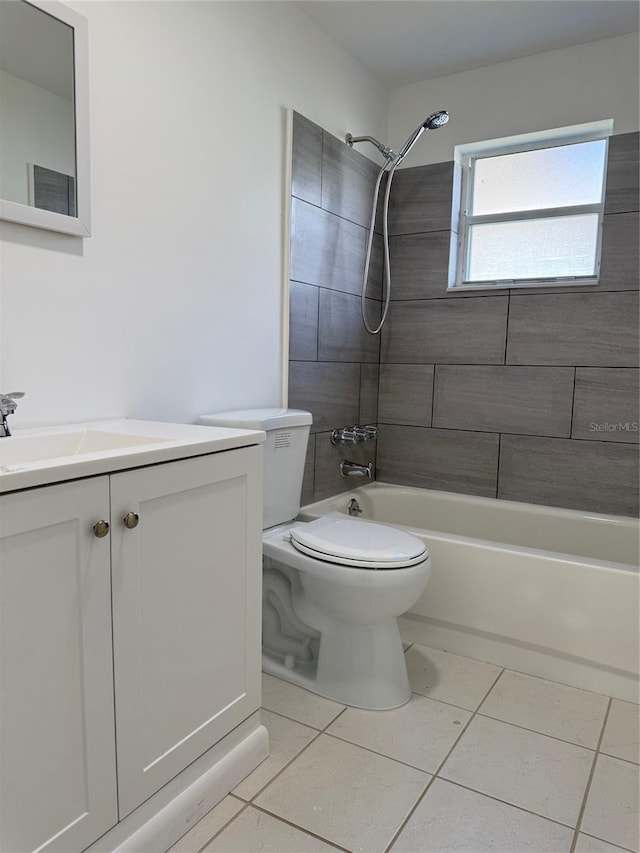 full bathroom featuring tile patterned flooring, vanity, tiled shower / bath combo, and toilet