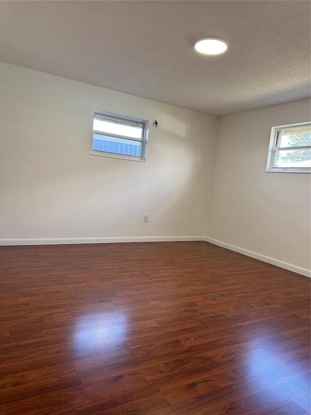 empty room featuring dark hardwood / wood-style flooring