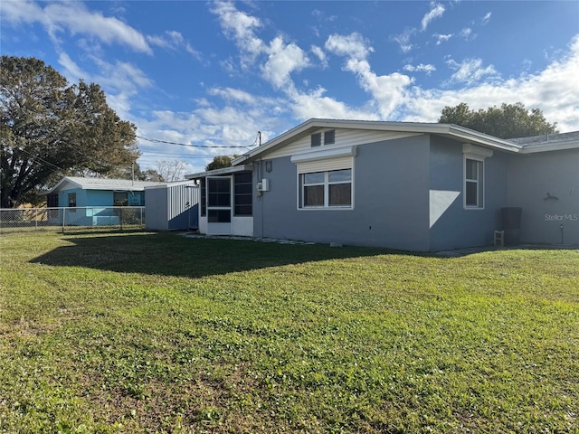 rear view of property with a lawn