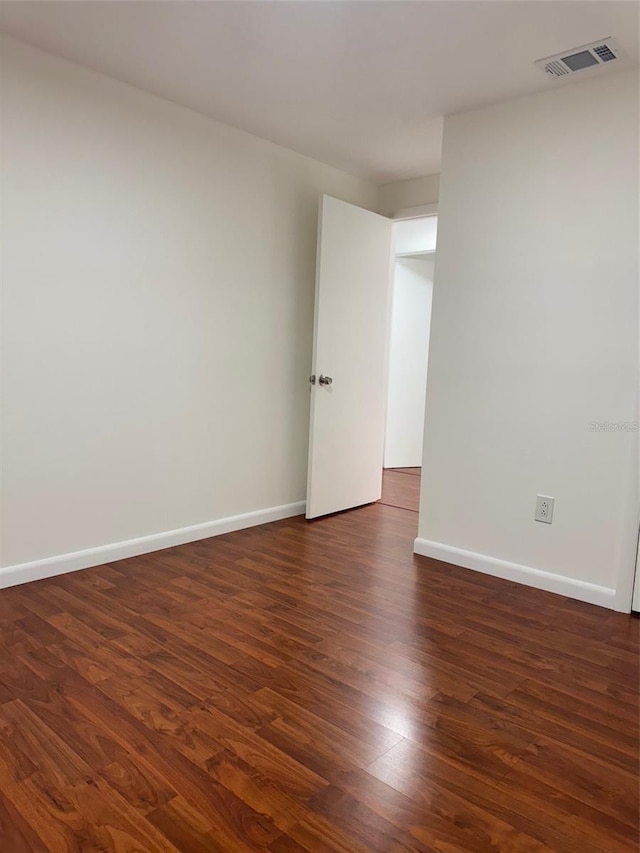 unfurnished room featuring dark hardwood / wood-style flooring