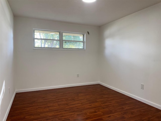 unfurnished room featuring dark wood-type flooring